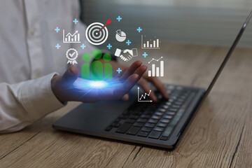 Business using laptop hand holding virtual team analytics icons,Concept digital strategy, business growth data analysis teamwork, performance management corporate planning modern technology solutions