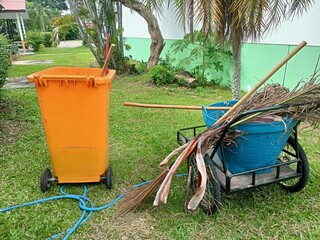 Garden Cleaning Tools with Cart, Broom, and Waste Bin on Green Lawn