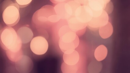 Soft-focus image with blurred orbs of light, predominantly pink and gold, creating a dreamy effect