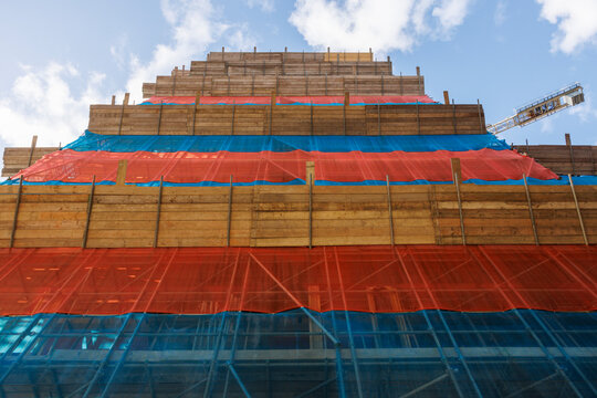 Scaffolding on a building that is being built.