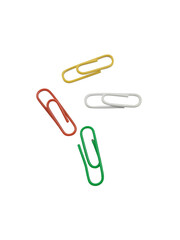A vibrant assortment of colorful paper clips scattered on a plain black background isolated on transparent background