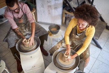 Group of people creative handmade workshop. Wet clay on wheel. Creative, hobby ,workshop  concept