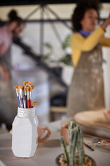 brushes on table in pottery studio where pot are painting with brushes. Creative, hobby ,activities concept