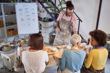 Teacher and group of people on handmade pottery workshop. Creative, hobby ,activities concept
