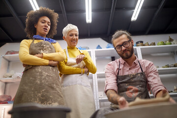 Group of people learning handmade poterry making. Creative, hobby ,workshop  concept