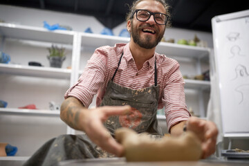 Happy man in his handmade pottery making studio. Creative, hobby ,workshop  concept