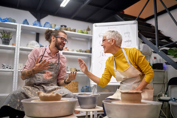 Artists having fun while making pots from clay in studio. . Modeling ,project.  Creative, hobby ,workshop  concept