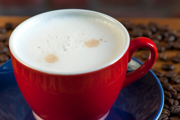 Red Cup of Cappuccino with Cinnamon Dusting