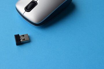 Fototapeta premium Usb flash drive on blue. Close-up of a wireless computer mouse on a blue background