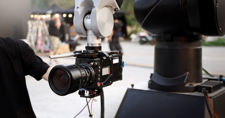 Behind the scenes of movie shooting or video production and film crew team with camera equipment at...