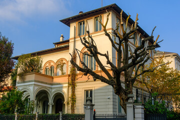 Old residential buildings along Via Bernardino Telesio in Milan, Italy