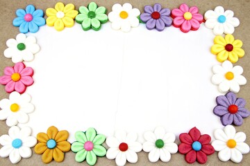Photo frame made of plasticine flowers. Flower frame