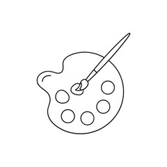 Artist's palette with paintbrush resting on it in a studio setting