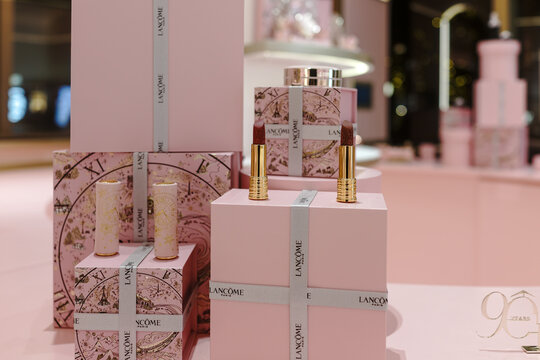 Lanc&ocirc;me 90th anniversary exhibition space featuring a pink-themed beauty counter with cosmetic displays and brand signage inside a retail environment.