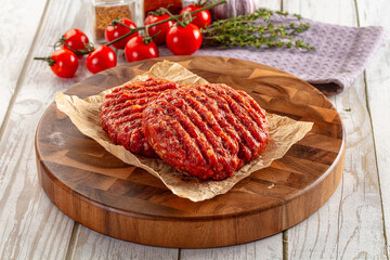 Raw uncoocked red beef round cutlet