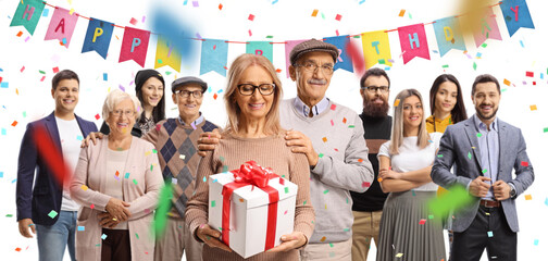 Mature woman celebrating birthday with family and friends