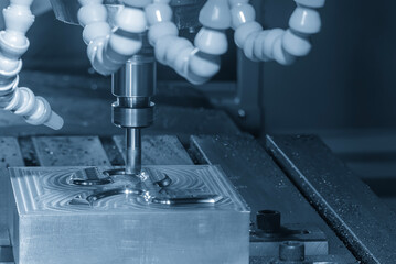 The CNC milling machine rough cutting the injection mold parts by indexable tools in the light blue...
