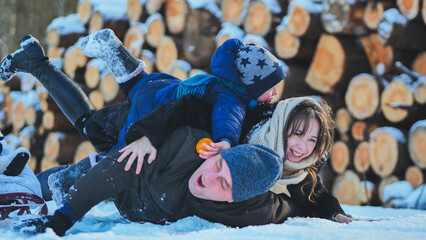 Cheerful family bonding, laughing while sledding together amid snowy winter landscape