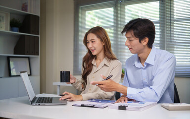 Confident businesswoman presenting ideas while collaborating with a colleague in a bright office.