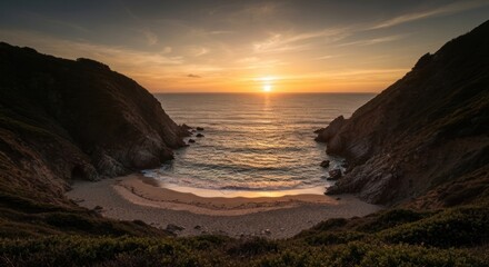 Dramatic sunset over secluded cove. Rocky coastline meeting sandy beach