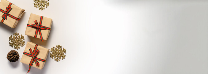 Christmas flat lay. Gift box, snowflake and pine on white background with space for text