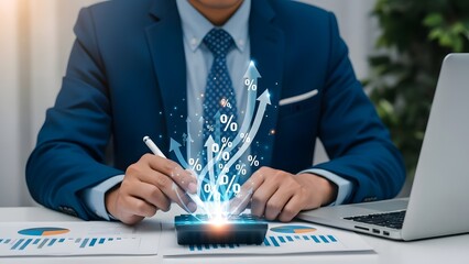 Businessman analyzing data on phone with laptop and papers on desk