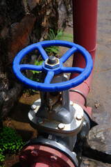 Large shut-off valve for opening and closing the water supply pipe. Hand wheel for closing and opening the water supply pipe

