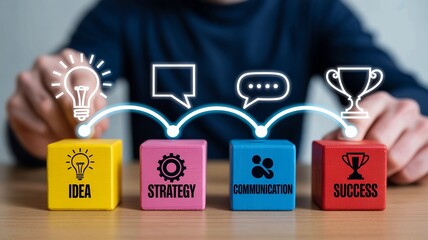Businessman arranging colorful blocks with idea strategy communication success concepts on wooden desk in office