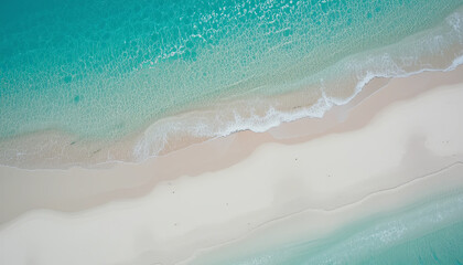White sand beach with clear blue water and gentle waves near a tropical island during a sunny day