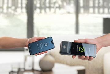 Smartphone payment approved on mobile POS terminal inside hotel lobby, representing secure digital transaction and modern hospitality checkout