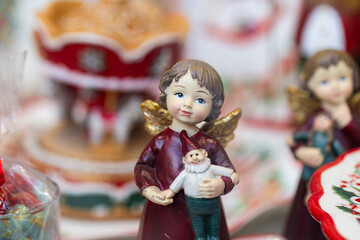 Christmas Angel Figurine Holding Small Gnome in Festive Shop Window Display