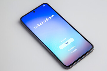 welcome screen on smartphone in Latvian