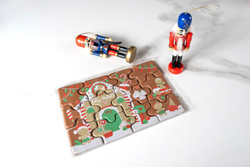 Milk chocolate puzzle next to Nutcracker dolls.