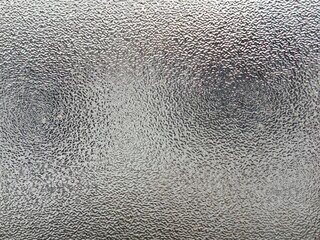 Blurred frosted glass texture. Window backdrop with shadows and reflections. Glass effect background. Abstract gradient bright light reflection and shiny rough texture surface	