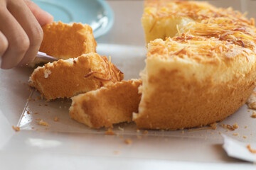 Close-Up of Knife Slicing Baked Cheese Bread