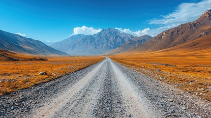 Mountain range landscape with a road leading towards the mountains