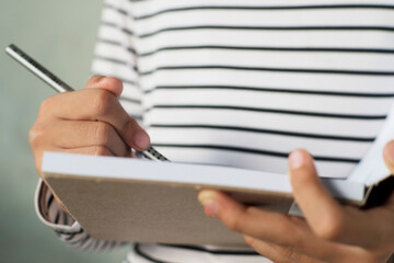 Personal Reflection in Cardboard-Backed Notebook