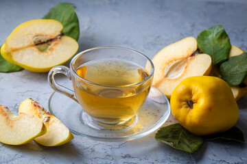 The cup of quince tea and fresh quince fruit