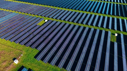 Huge area with technological photovoltaic cells converting sunlight into electricity. Usage of nature for green energy production. Aerial view.