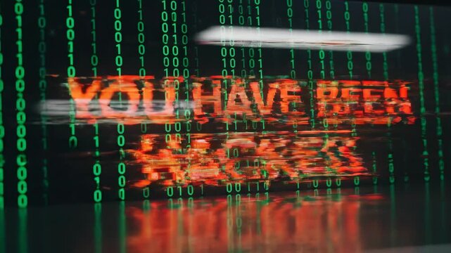TILE: Computer screen displaying you have been hacked message over green binary code data stream, illustrating concept of cyber security breach