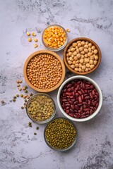 Assortment of dried legumes and grains in bowls