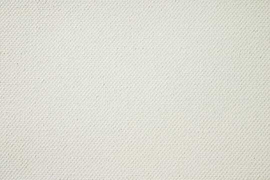 Off-white twill fabric texture. A close-up view of a cream-colored diagonal weave textile showing fine thread details.