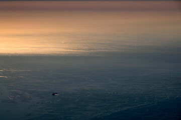 big ship container aerial view from airplane window ad sunset