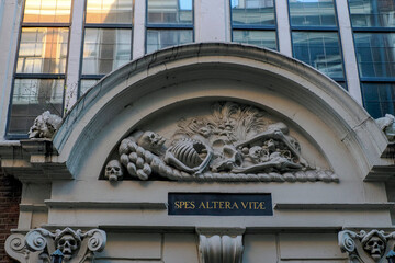 Spes altera vitae skeleton in amsterdam old town buildings detail