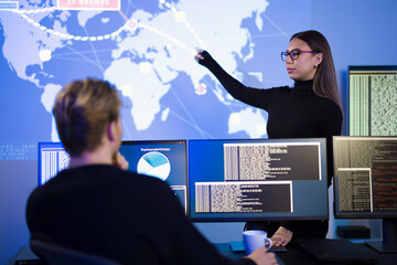Cybersecurity analysts collaboratively investigating threats in a high-tech monitoring center