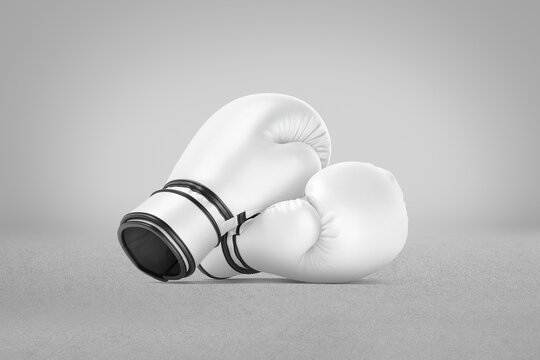 Blank white boxing gloves pair mockup lying, grey background