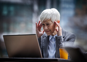 Business woman thinking of problem in outdoor cafe