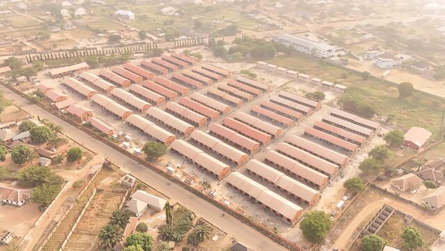 Aerial view of rows of market stalls stretch out, a grid of commerce under the hazy sky, Senator George Akume Way, Makurdi, Benue, Nigeria.