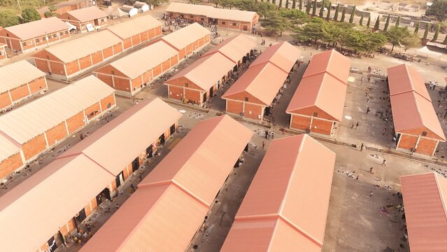Aerial view of rows of red-roofed buildings casting shadows on the ground, creating a geometric pattern of light and shade, Makurdi, Benue, Nigeria.