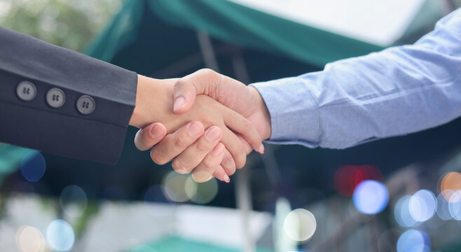 close up manager businessman handshake with investor woman after complete from special offer deal about investment and agreement contract for developing and improve business in new year 2026 target